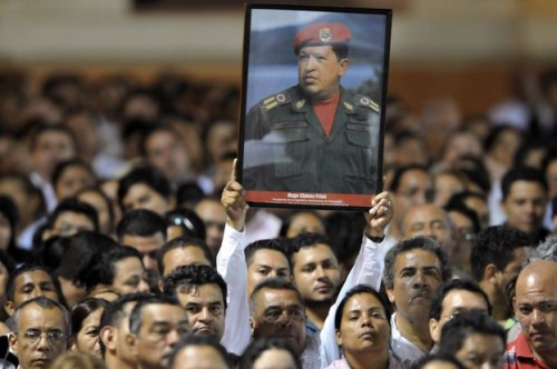 A Nicaraguan supporter of Venezuelan President Hugo Chavez holds a poster of him at the Revolution Square in Managua